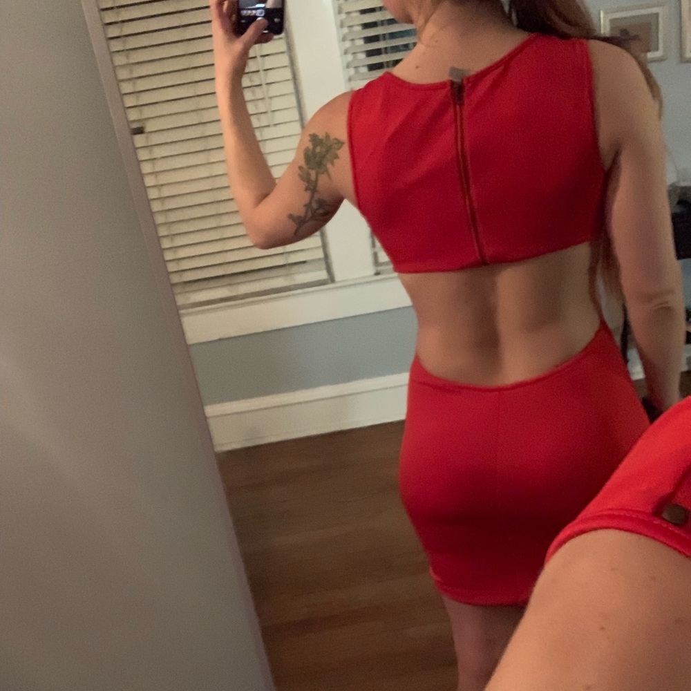 orangey-red fitted open back dress with studs